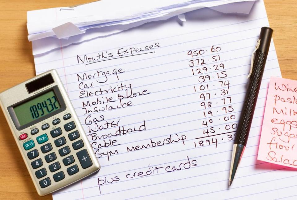 handwritten list of expenditure plus calculator