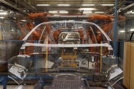 Ford Fiestas are seen on a body shell production line in Cologne September 19, 2013. REUTERS/Wolfgang Rattay