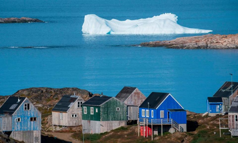 Icebergs float behind the town of Kulusuk in Greenland on August 16, 2019