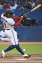 Toronto Blue Jays' Bo Bichette fouls the ball off of his foot during the first inning of the team's baseball game against the Cleveland Indians on Wednesday, Aug. 4, 2021, in Toronto. (Jon Blacker/The Canadian Press via AP)