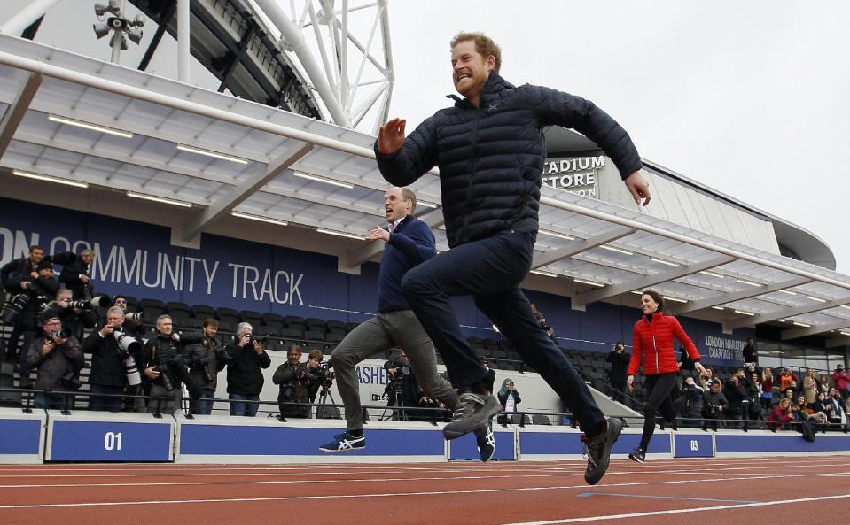 Britain's Prince William, background centre, Kate, the Duchess of Cambridge, background right, and Prince Harry take part in a relay race, during a training event to promote the charity Heads Together, at the Queen Elizabeth II Park in London, Sunday, Feb. 5, 2017. (AP Photo/Alastair Grant, Pool)