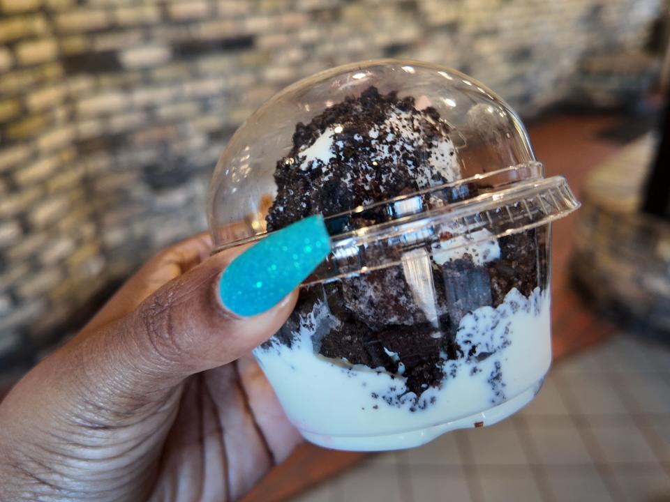 hand holding an oreo sundae with vanilla frozen custard at kopps