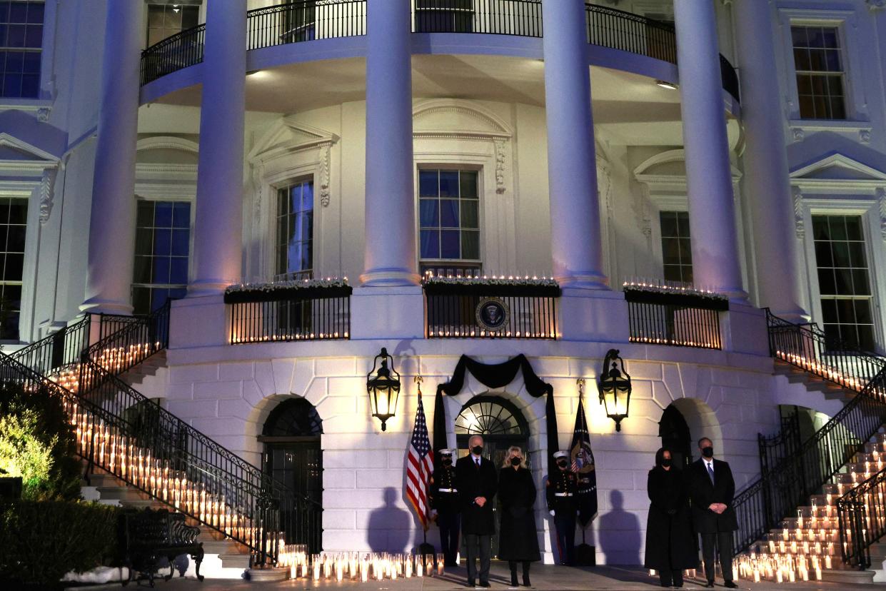 (L-R) U.S. President Joe Biden, First Lady Jill Biden, Vice President Kamala Harris and Second Gentleman Doug Emhoff participate in a moment of silence at sundown in the South Portico of the White House on Feb. 22, 2021, in Washington, DC. The four held a candlelight ceremony to mark the more than 500,000 lives lost in the U.S. to COVID-19 since the pandemic hit.