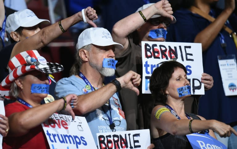 Bernie Sanders' supporters protest with their mouths taped on Day 1 of the Democratic National Convention in Philadelphia, Pennsylvania