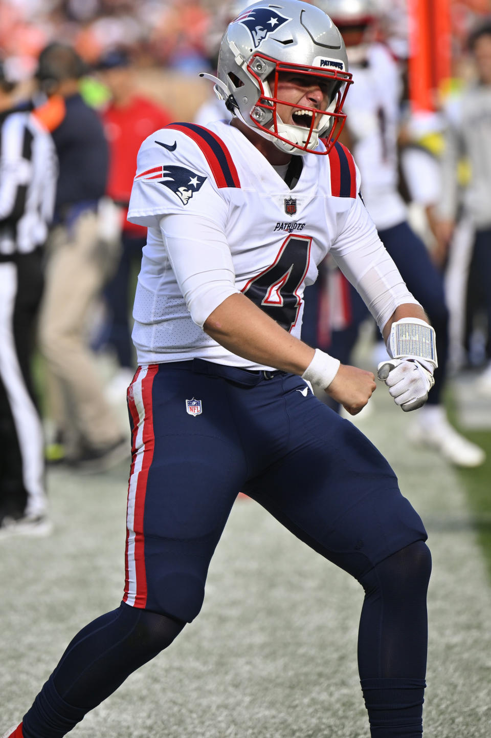 New England Patriots quarterback Bailey Zappe (4) celebrates after throwing a touchdown pass to tight end Hunter Henry (85) during the second half of an NFL football game against the Cleveland Browns, Sunday, Oct. 16, 2022, in Cleveland. (AP Photo/David Richard)