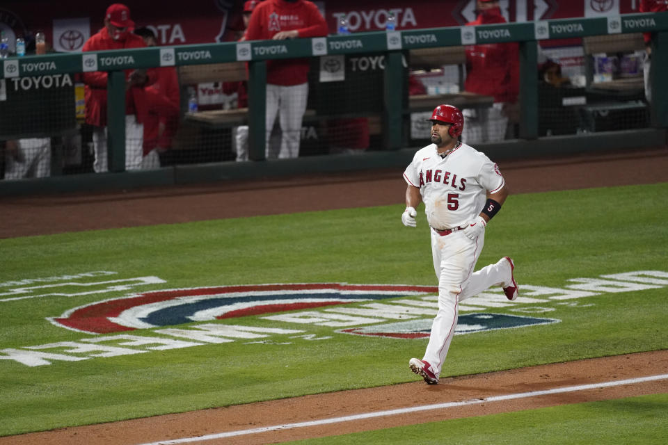 Los Angeles Angels' Albert Pujols (5) runs the bases after hitting a home run during the fourth inning of an MLB baseball game against the Chicago White Sox Friday, April 2, 2021, in Anaheim, Calif. Mike Trout and Justin Upton also scored. (AP Photo/Ashley Landis)