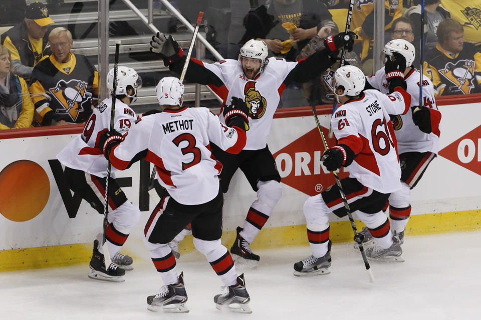<p>Ottawa Senators’ Bobby Ryan, center, celebrates with teammates Marc Methot (3), Derick Brassard (19), Mark Stone (61) and Jean-Gabriel Pageau (44) after scoring the game-winning goal against the Pittsburgh Penguins during the overtime period of Game 1 of the Eastern Conference final in the NHL hockey Stanley Cup playoffs, Saturday, May 13, 2017, in Pittsburgh. Ottawa won 2-1 in overtime. (Photo: Gene J. Puskar/AP) </p>