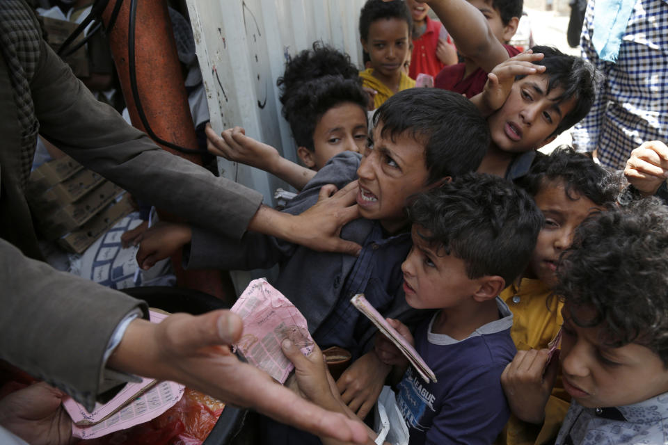 SANA'A, YEMEN - JUNE 29: Yemeni children, from families who were affected by the war and blockade, flock to receive free lunch meals, provided by a charitable kitchen at Mseek area on June 29, 2021 in Sana'a, Yemen. Since the conflict erupted in Yemen more than six years ago, the country's humanitarian crisis remains the worst in the world, as 20.7 million people, 71 percent of the nation's 28 million population, is in need of humanitarian assistance. More than three million people, including 1.58 million children, internally displaced, and 138,000 additional people have become migrants while 137,000 people are seeking asylum abroad. (Photo by Mohammed Hamoud/Getty Images)