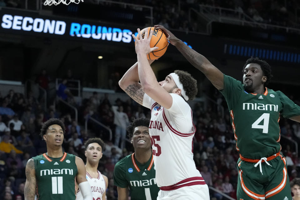 Miami's Bensley Joseph (4) blocks a shot by Indiana's Race Thompson (25) in the first half of a second-round college basketball game in the NCAA Tournament, Sunday, March 19, 2023, in Albany, N.Y. (AP Photo/John Minchillo)