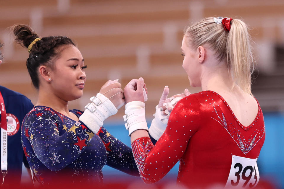 Sunisa Lee and Jade Carey fist bump during Women's Qualification at the Tokyo 2020 Olympic Games on July 25, 2021. / Credit: Getty Images