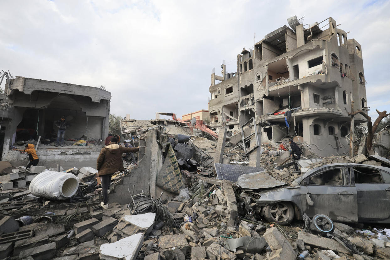Palestinians inspect the damage at the Al-Maghazi refugee camp after an Israeli strike (Mahmud Hams / AFP - Getty Images)