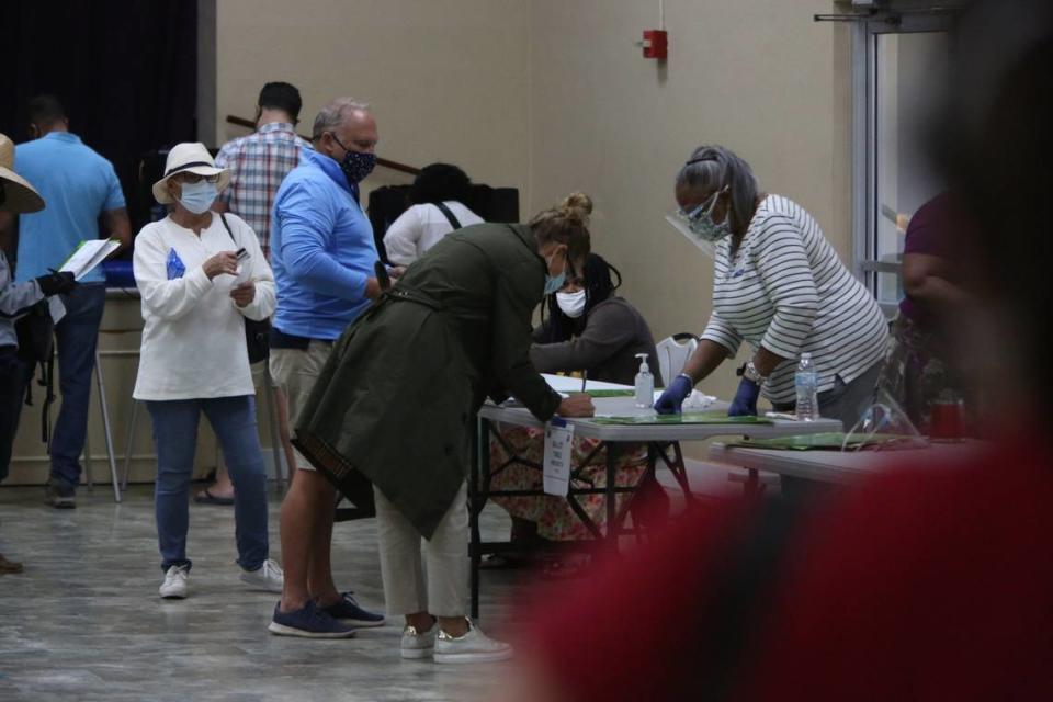 Approximately 50 voters waited in line during  a brief flurry of activity as doors opened at 7 a.m. Tuesday, Nov. 3, 2020,  at the C . Lawton McCall Community Center in Miami Shores. They flowed in and right out again after casting their votes and by 7:37 a.m. there was no longer a line.