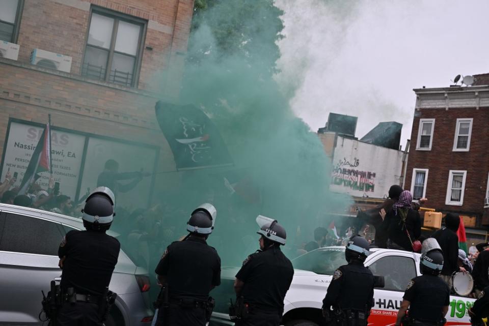 Protestors release green smoke. Paul Martinka for NY Post