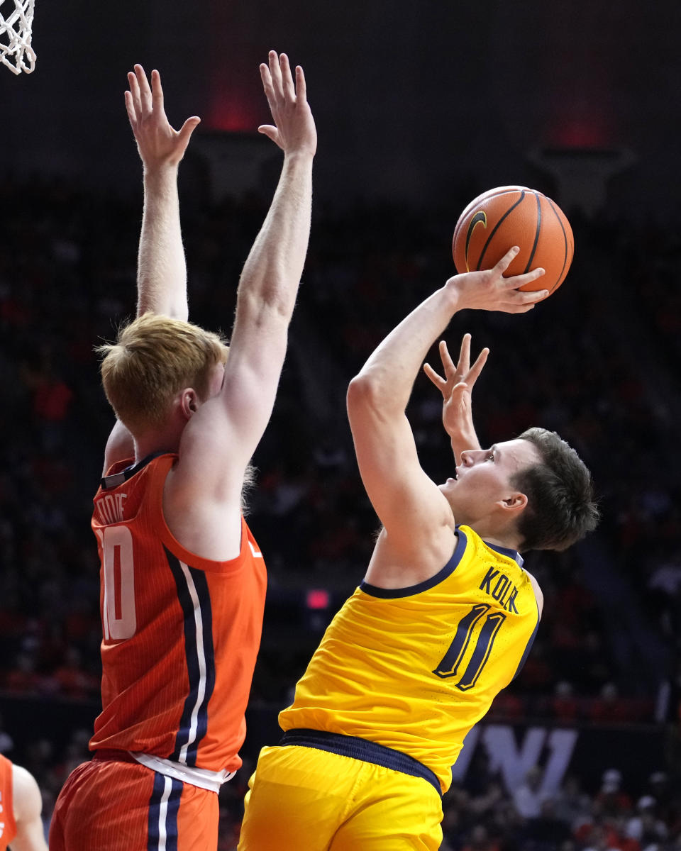 Marquette guard Tyler Kolek (11) shoots as Illinois guard Luke Goode defends during the second half of an NCAA college basketball game Tuesday, Nov. 14, 2023, in Champaign, Ill. Marquette won 71-64. (AP Photo/Charles Rex Arbogast)