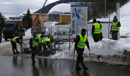 Soldiers of the Swiss army build protection fences for the upcoming World Economic Forum (WEF) in the Swiss mountain resort of Davos, Switzerland, January 11, 2018. REUTERS/Arnd Wiegmann