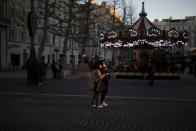 FILE - In this Jan. 14, 2021, file photo, people take a selfie together on a main street before a curfew is enforced to prevent the spread of the coronavirus in Marseille, southern France. While most of Europe kicked off 2021 with earlier curfews or stay-at-home orders, authorities in Spain insist the new coronavirus variant causing havoc elsewhere is not to blame for a sharp resurgence of cases and that the country can avoid a full lockdown even as its hospitals fill up. (AP Photo/Daniel Cole, File)