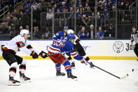 New York Rangers defenseman Adam Fox (23) takes a shot for a goal as he is checked by Ottawa Senators left wing Dominik Kubalik (81) during the second period of an NHL hockey game Monday, April 15, 2024, at Madison Square Garden in New York. (AP Photo/Bill Kostroun)