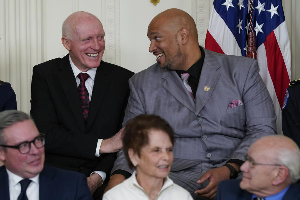 Former Arizona state House Speaker Rusty Bowers, left, speaks with U.S. Capitol Police Sgt. Harry Dunn in the East Room of the White House in Washington, Friday, Jan. 6, 2023, during a ceremony to mark the second anniversary of the Jan. 6 assault on the Capitol and to award Presidential Citizens Medals to state and local officials, election workers and police officers for their "exemplary deeds of service for their country or their fellow citizens" in upholding the results of the 2020 election and fighting back the Capitol mob. (AP Photo/Patrick Semansky)