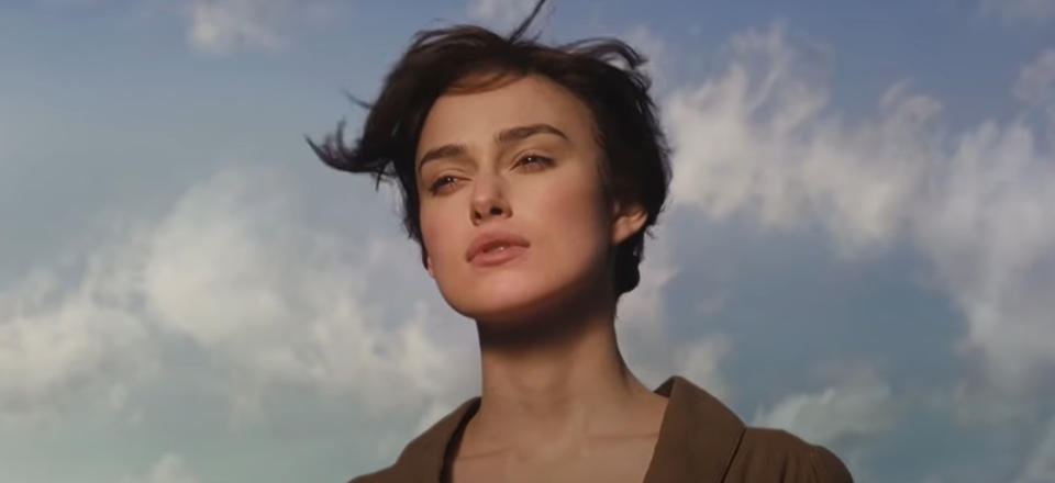 Keira Knightley gazing thoughtfully against a cloudy sky backdrop in Pride and Prejudice