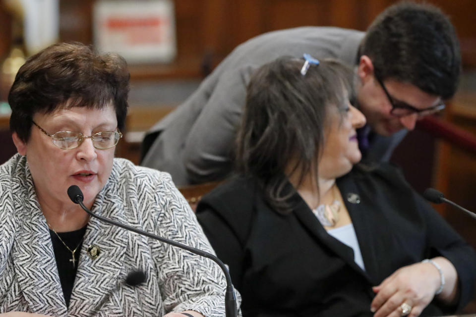 Pittsburgh City Council member Darlene Harris, left, speaks on a vote on gun-control legislation as fellow council members Corey O'Connor, right, and Theresa Smith, center, have a discussion, during a City Council meeting, Wednesday, March 27, 2019, in Pittsburgh. The bill passed as members voted 6-3 to pass tentative approval to the gun-control legislation introduced in the wake of the synagogue massacre last October. The legislation would place restrictions on military-style assault weapons like the AR-15 rifle that authorities say was used in the attack that killed 11 and wounded seven. A final vote will take place next week. Harris, Smith and Anthony Coghill voted against the bill O'Connor co-sponsored. (AP Photo/Keith Srakocic)
