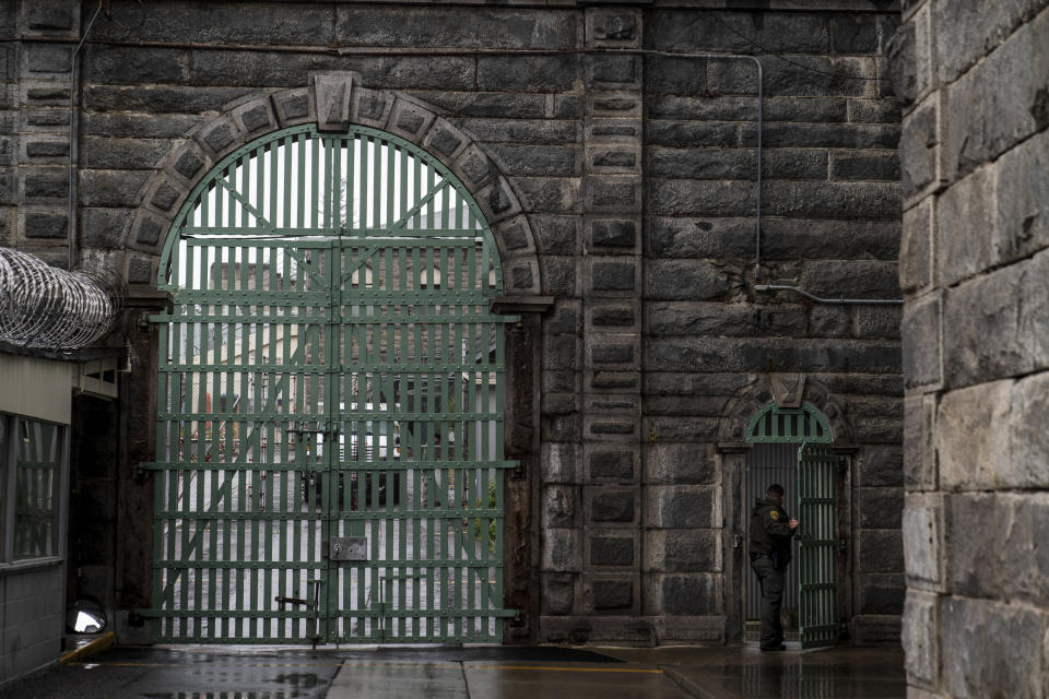 A prison guard walks through a gate at Folsom State Prison in Folsom, Calif., Thursday, May 4, 2023. Under the Free Application for Federal Student Aid (FAFSA) Simplification Act, more than 760,000 people in prison will become eligible for Pell Grants once the law is implemented on July 1. Prison education advocates say it's not a matter of if, but when recidivism rates drop and job attainment begins to rise. (AP Photo/Jae C. Hong)