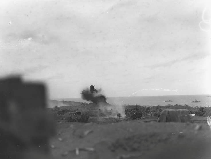 A U.S. Marine half-track self-propelled gun blasts an enemy-occupied pillbox on Iwo Jima