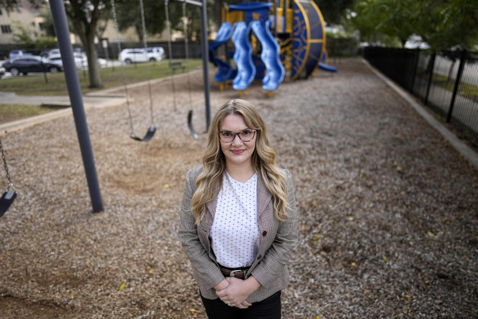 Natalie Rincon poses for a photograph outside a Houston elementary school Thursday, Nov. 17, 2022, in Houston. Rincon, one of the new social workers, has seen firsthand the benefit of having a fuller mental health team at her elementary school, where many students are refugees or newly arrived immigrant students coping with trauma from their migration. (AP Photo/David J. Phillip)