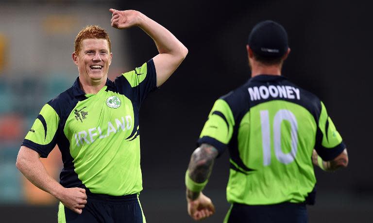 Ireland all-rounder Kevin O'Brien (L) celebrates with teammate John Mooney after taking the wicket of unseen Zimbabwe batsman Hamilton Masakadza at the Bellerive Oval in Hobart during the 2015 Cricket World Cup Pool B match on March 7, 2015