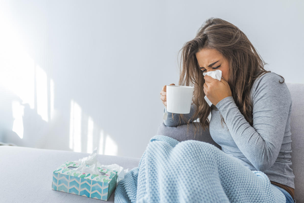 Cold And Flu. Portrait Of Ill Woman Caught Cold, Feeling Sick And Sneezing In Paper Wipe. Closeup Of Beautiful Unhealthy Girl Covered In Blanket Wiping Nose. Healthcare Concept. High Resolution