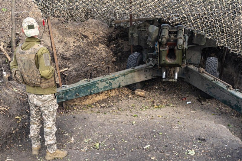 A Ukrainian artillery man stands near a Soviet-era D-20 artillery piece. Photo by Dylan Burns/UPI