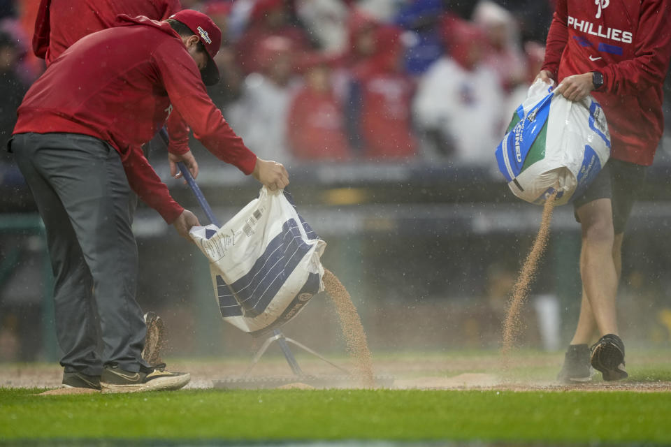 The grounds crew works the field during the seventh inning in Game 5 of the baseball NL Championship Series between the San Diego Padres and the Philadelphia Phillies on Sunday, Oct. 23, 2022, in Philadelphia. (AP Photo/Matt Slocum)