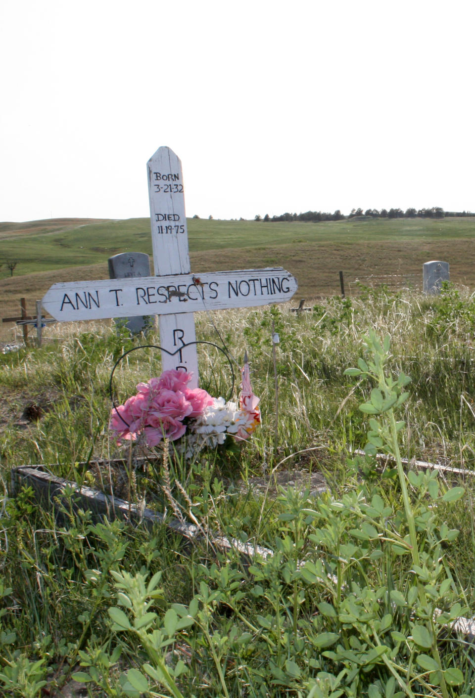 This May 13, 2012, photo shows a gravesite at the Wounded Knee Cemetery in Wounded Knee, S.D. The site, located on the Pine Ridge Indian Reservation, which is home to the Oglala Sioux Tribe, is where more than 250 Lakota men, women and children were killed by the 7th Cavalry in 1890. Some tribal members believe the area should be developed into a tourist attraction with a museum. Others, however, are adamantly opposed to development at the site, saying it would be disrespectful since it’s a mass gravesite. (AP Photo/Kristi Eaton)