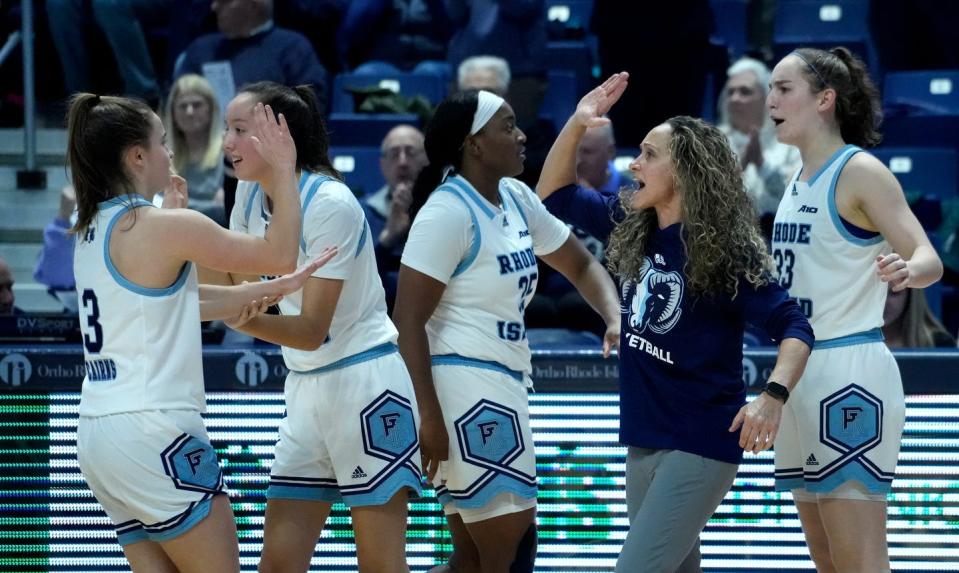 URI women's basketball coach Tammi Reiss high-fives players during a game last season.