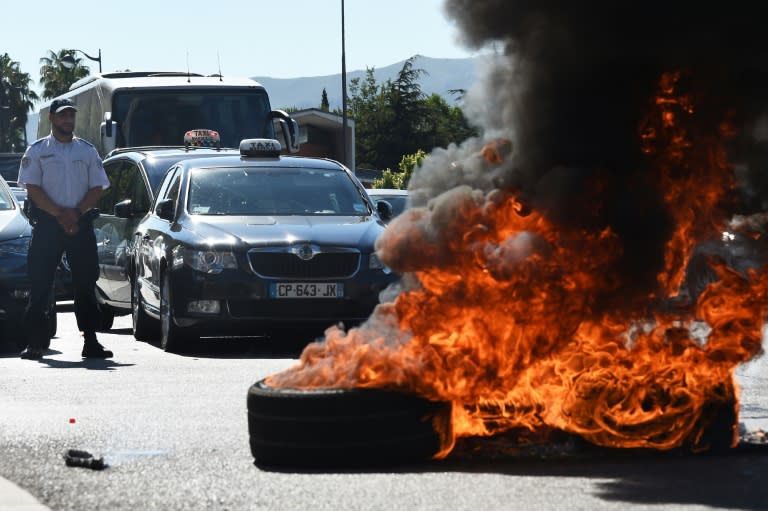 French taxi drivers burn tyres in the southern city of Marseille on June 25, 2015 in an anti-UberPOP demonstration