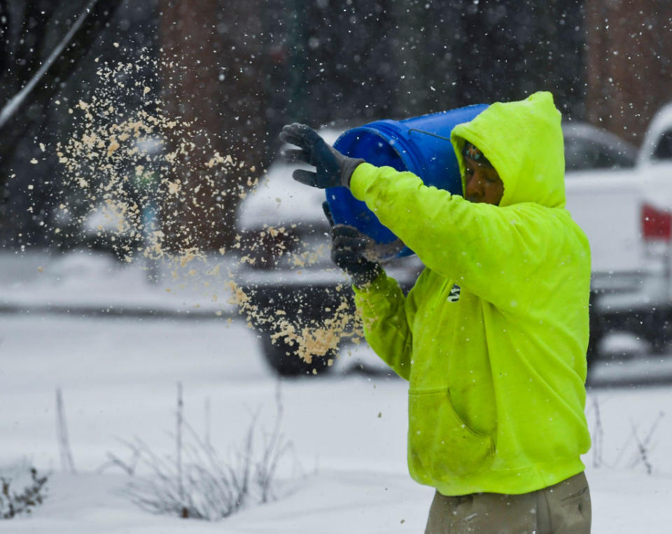 A public works employee spreads salt on sidewalks in Reading, PA during a snowstorm on Feb. 18, 2021.<span class="copyright">Ben Hasty—MediaNews Group/Reading Eagle/Getty Images</span>