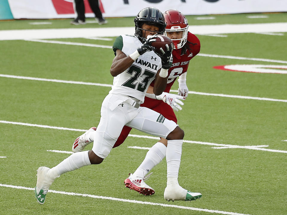 Hawaii wide receiver Jared Smart catches a long pass past Fresno State defensive back Levelle Bailey during the first half of an NCAA college football game in Fresno, Calif., Saturday, Oct. 24, 2020. (AP Photo/Gary Kazanjian)