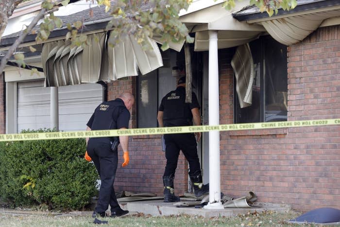 Investigators enter the house where eight people died in an apparent murder-suicide involving two adults and six children in Broken Arrow, Oklahoma, on Oct. 28, 2022.