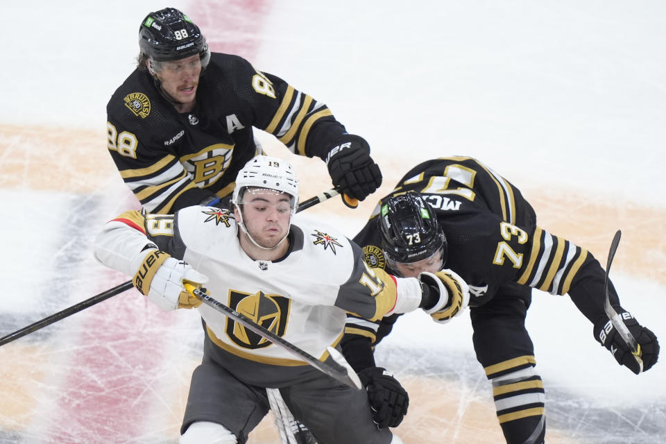 Vegas Golden Knights center Brendan Brisson (19) vies for position with Boston Bruins right wing David Pastrnak (88) and defenseman Charlie McAvoy (73) in the second period of an NHL hockey game, Thursday, Feb. 29, 2024, in Boston. (AP Photo/Steven Senne)