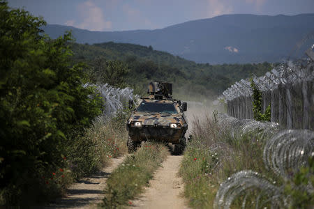 Macedonian soldiers patrol at the Macedonia-Greece border near Gevgelija, Macedonia, June 3, 2018. REUTERS/Marko Djurica