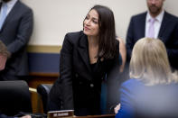 Rep. Alexandria Ocasio-Cortez, D-N.Y., appears before Facebook CEO Mark Zuckerberg arrives for a House Financial Services Committee hearing on Capitol Hill in Washington, Wednesday, Oct. 23, 2019, on Facebook's impact on the financial services and housing sectors. (AP Photo/Andrew Harnik)