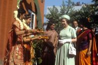 <p>The Queen is offered food by girls in traditional Indian dress at the Mahatma Gandhi memorial at Raj Ghat, Delhi. (PA Archive) </p>