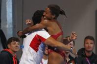 Diving - Gold Coast 2018 Commonwealth Games - Women's 3m Springboard Final - Optus Aquatic Centre - Gold Coast, Australia - April 14, 2018. Jennifer Abel of Canada hugs her coach. REUTERS/David Gray