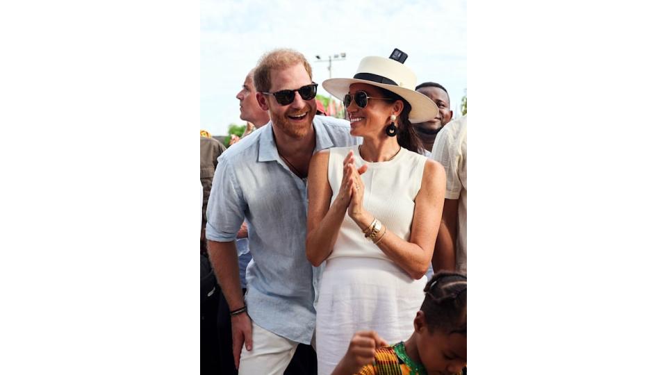 Prince Harry and Meghan wearing sunglasses and smiling in Colombia