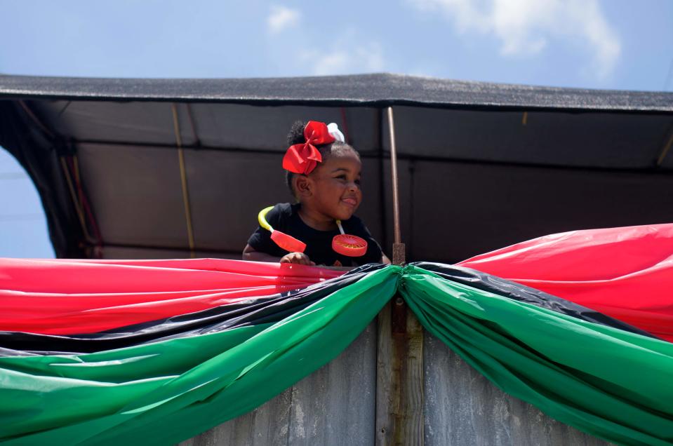 A girl looks out from a parade float during a Juneteenth parade in Galveston, Texas, on June 19, 2021. - The US on June 17 designated Juneteenth, which marks the end of slavery in the country, a federal holiday with President Joe Biden urging Americans "to learn from our history."