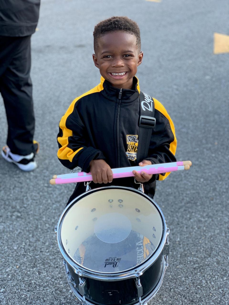 Jeremiah Travis, 5, smiles while standing at attention with his drum. Jeremiah, a band member at St. Helena College and Career Academy in Greensburg, La., was offered a full band scholarship to Alcorn State University this month.