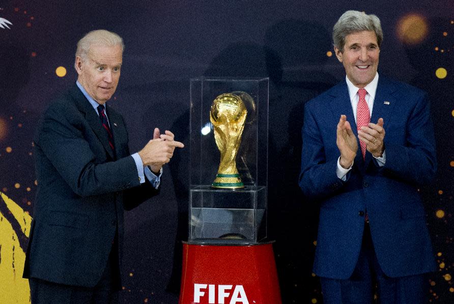 Vice President Joe Biden and Secretary of State John Kerry applaud after unveiling the FIFA World Cup trophy, the actual trophy that will be awarded to the winner of this year’s World Cup soccer tournament in Brazil, during a ceremony at the State Department in Washington, Monday, April 14, 2014. (AP Photo/Manuel Balce Ceneta)