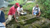 In this March 1, 2011 photo released by the Philippine National Museum, Filipino archeologists measure the dimensions of a limestone coffin at Mount Kamhantik, near Mulanay town in Quezon province, eastern Philippines. Archeologists have unearthed remnants of what they believe is a 1,000-year-old village on a jungle-covered mountaintop in the Philippines with limestone coffins of a type never before found in this Southeast Asian nation, officials said, Thursday, Sept. 20, 2012. (AP Photo/Philippine National Museum) EDITORIAL USE ONLY, NO SALES