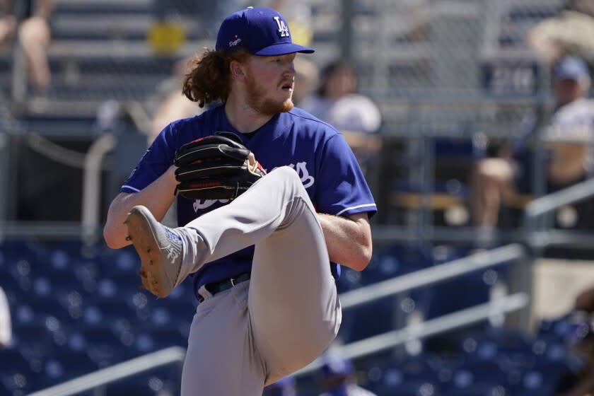 Los Angeles Dodgers' Dustin May pitches in the first inning of a spring training baseball game.