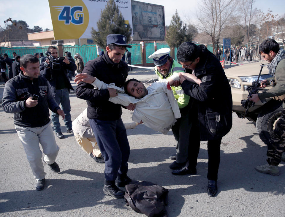 <p>People carry an injured man after a blast in Kabul, Afghanistan, Jan. 27, 2018. (Photo: Mohammad Ismail/Reuters) </p>