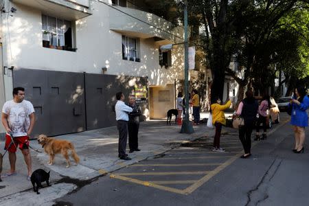 People wait outside their homes after an earthquake was felt in Mexico City, Mexico July 19, 2018. REUTERS/Carlos Jasso